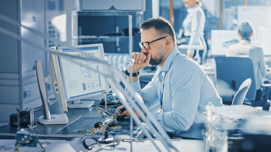 Man in lab sat at computer